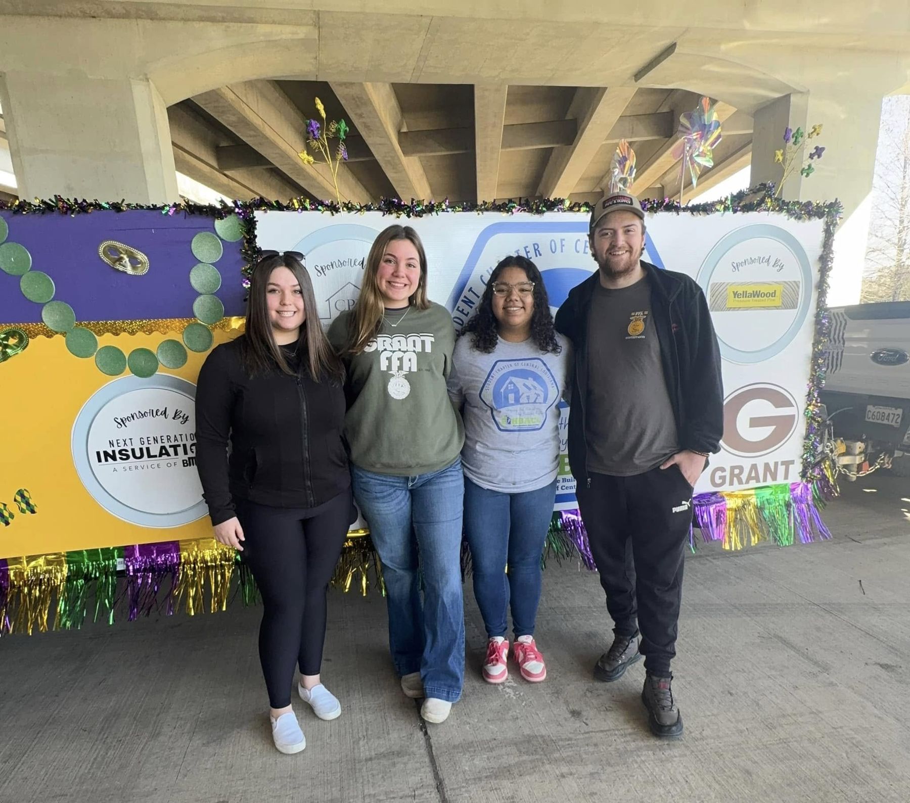 Students and volunteers in front of the chapter parade float