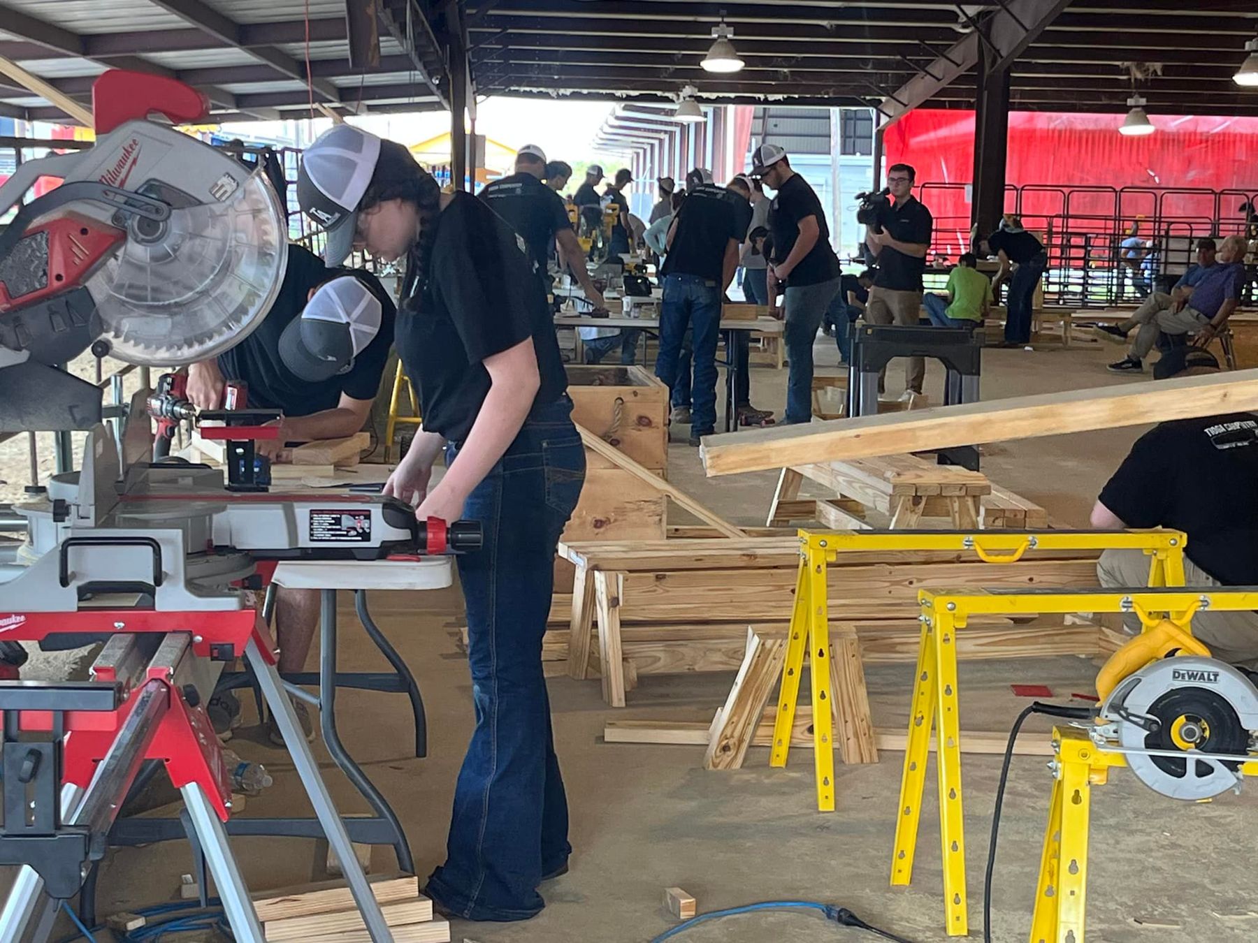 Student using a miter saw in a carpentry workshop