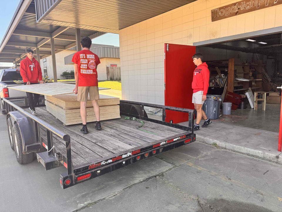 Students loading materials onto a trailer